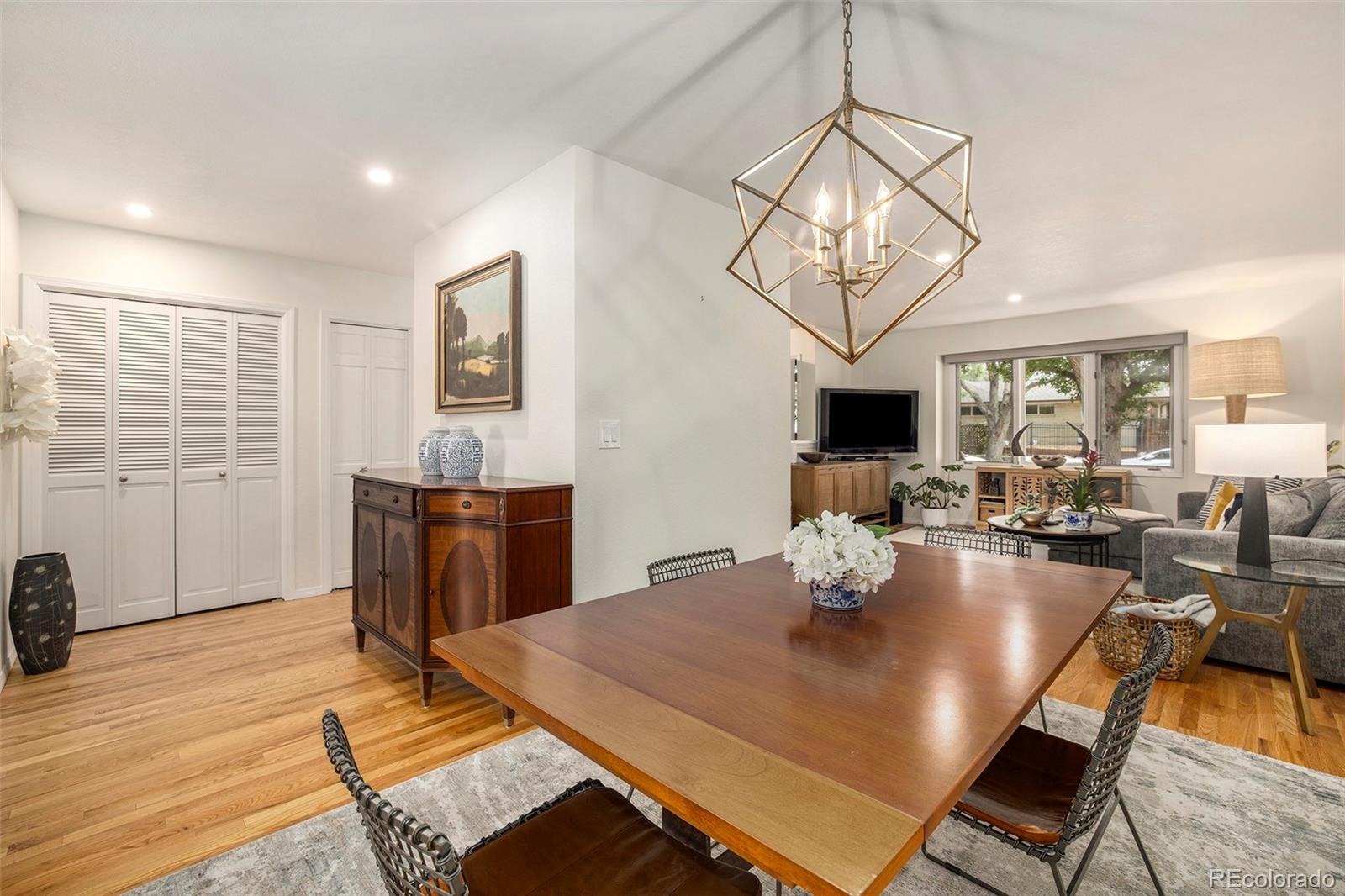 2365 Perry Street Denver, CO 80212 - Photo 6 of 24 a view of a dining room with furniture a chandelier and wooden floor