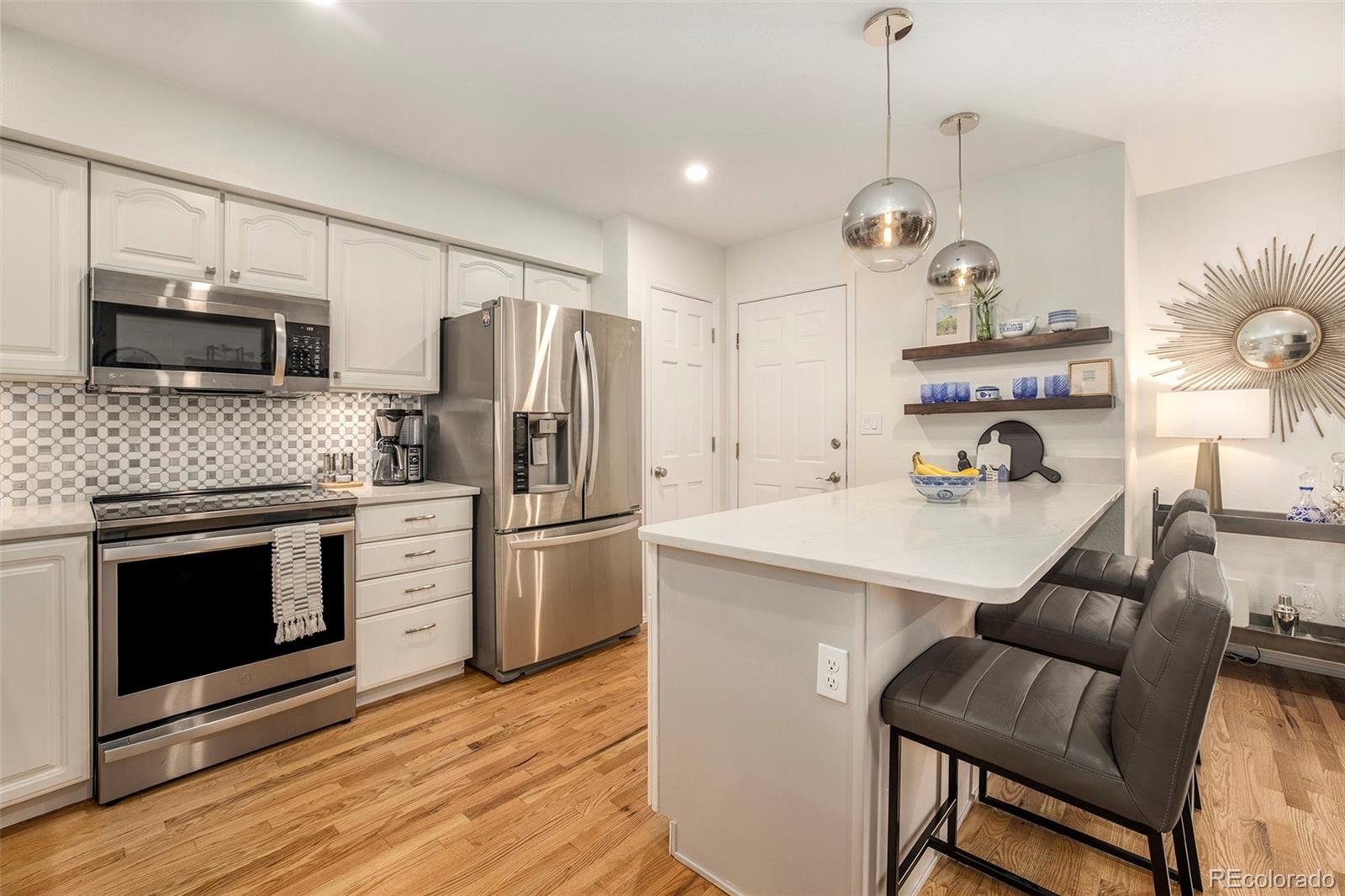 2365 Perry Street Denver, CO 80212 - Photo 10 of 24 a kitchen with stainless steel appliances a stove a sink and a refrigerator