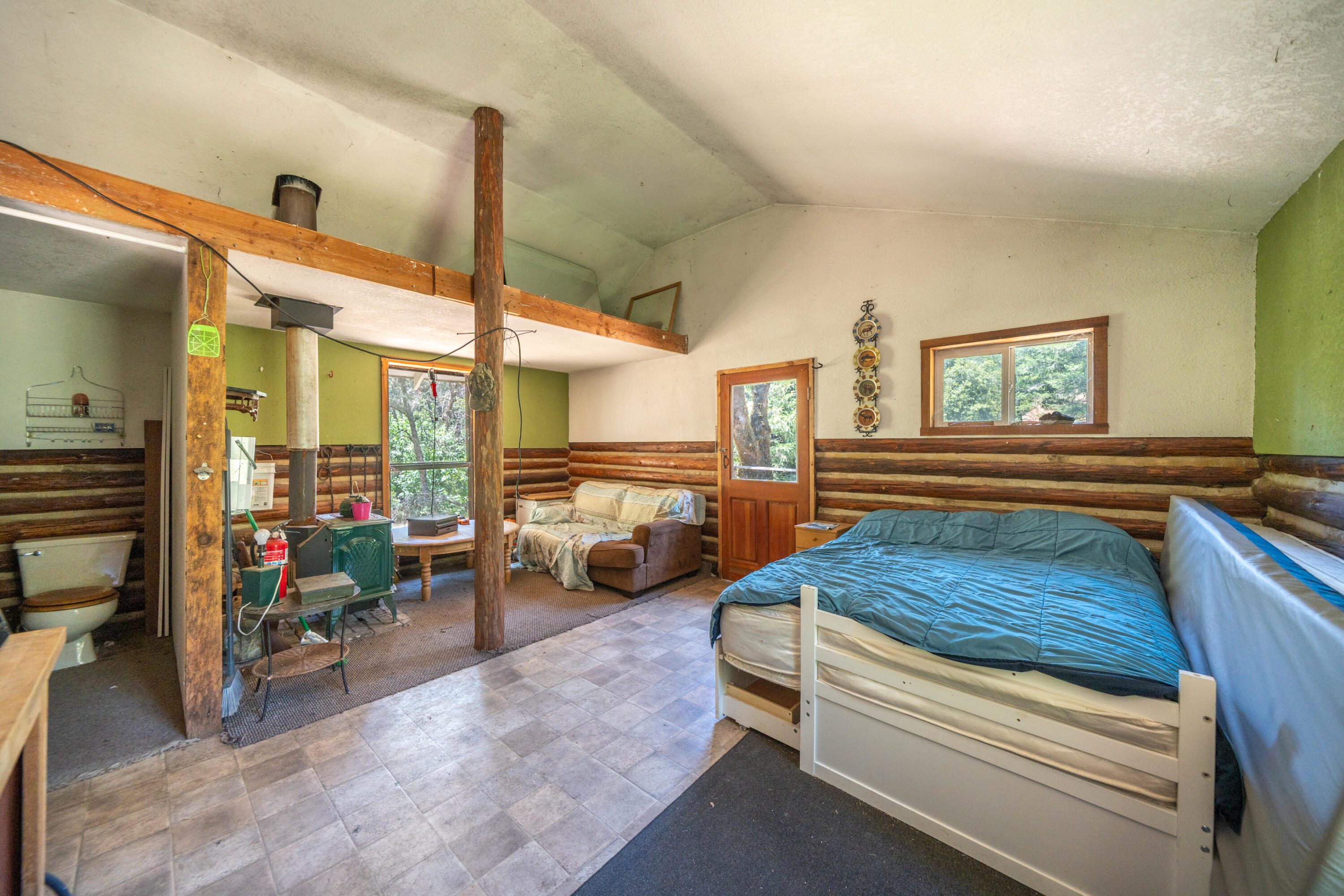 0 East Fork Road French Gulch, CA 96033 - Photo 29 of 78 a bedroom with furniture and a large window