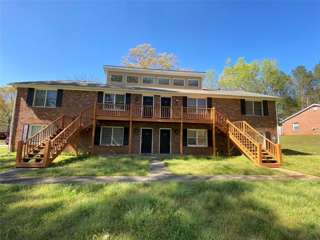 a view of a house with pool and chairs