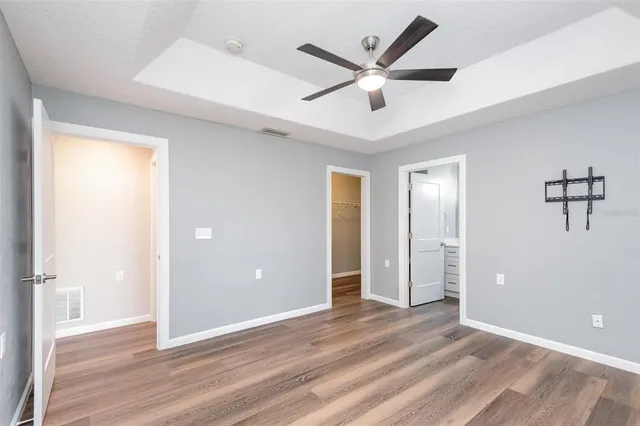 a view of a livingroom with a ceiling fan and wooden floor