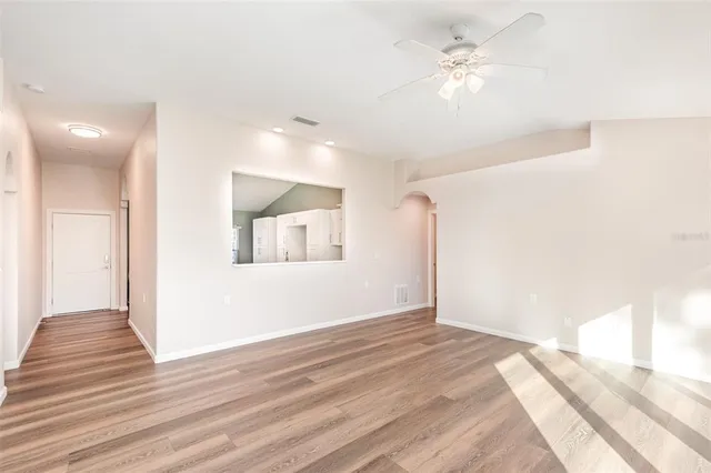 a view of a bedroom with wooden floor
