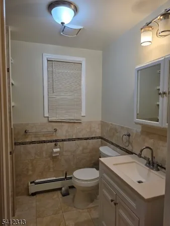 a bathroom with a sink a toilet and mirror