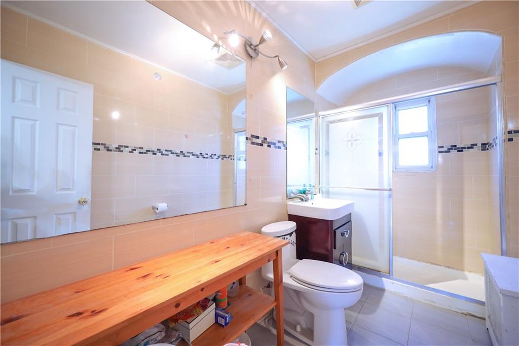3098 Nostrand Avenue Brooklyn, NY 11229 - Photo 11 of 17 a bathroom with a sink a toilet and shower