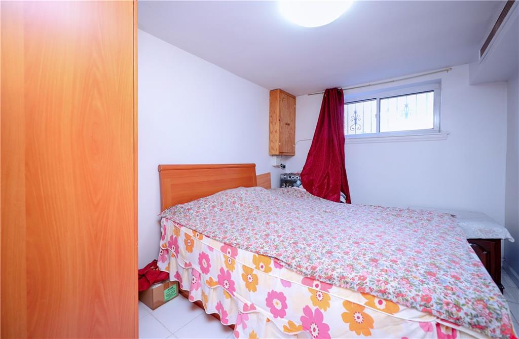 3098 Nostrand Avenue Brooklyn, NY 11229 - Photo 14 of 17 a bedroom with a bed and a painting on the wall