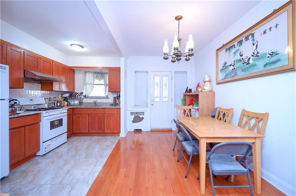 3098 Nostrand Avenue Brooklyn, NY 11229 - Photo 8 of 17 a kitchen with stainless steel appliances granite countertop a sink dishwasher stove and refrigerator with wooden floor