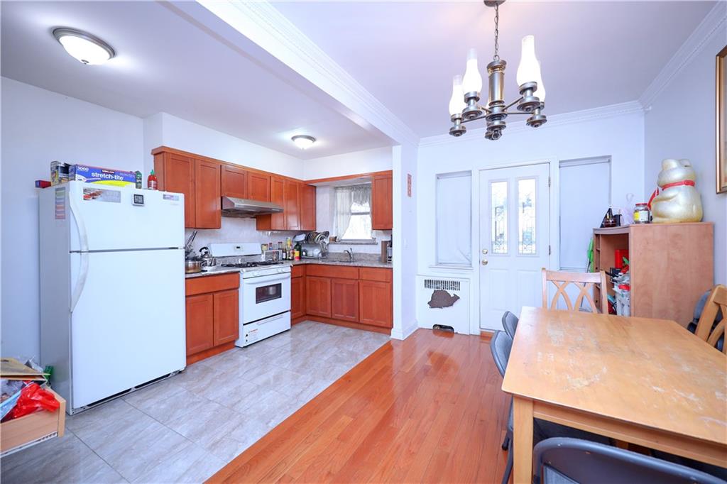 3098 Nostrand Avenue Brooklyn, NY 11229 - Photo 9 of 17 a kitchen with a refrigerator a stove top oven a sink dishwasher and wooden floor