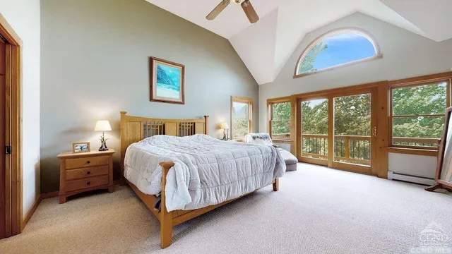 a spacious bedroom with a bed and a large window