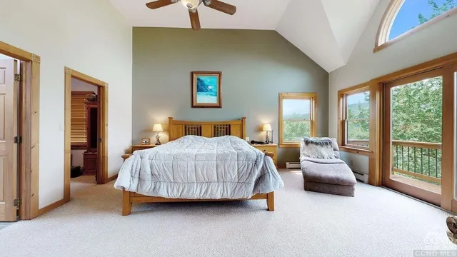 a bedroom with a large bed and a large window