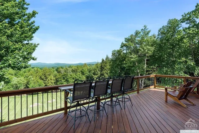 a view of balcony with furniture and wooden deck