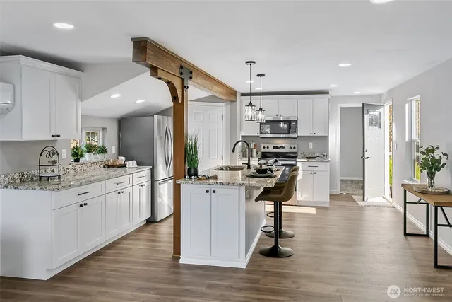 a kitchen with sink a stove and cabinets