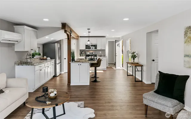 a living room with fireplace furniture and a wooden floor