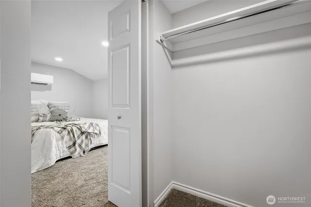 a view of walk in closet with clothes