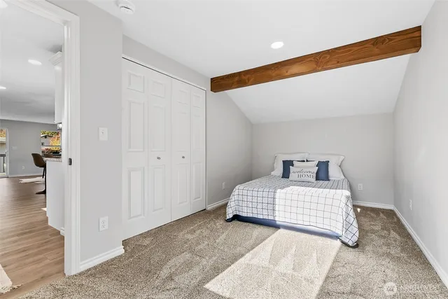 a bedroom with a bed and a night stand