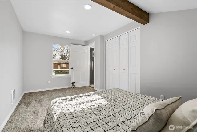 a bedroom with a bed and a window