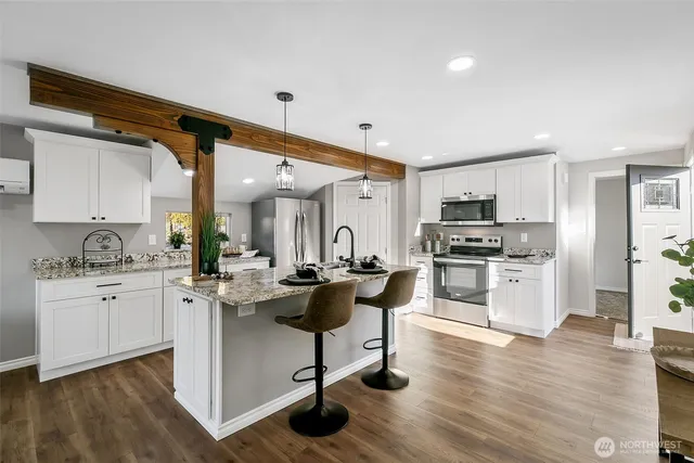 a kitchen with sink stove and cabinets