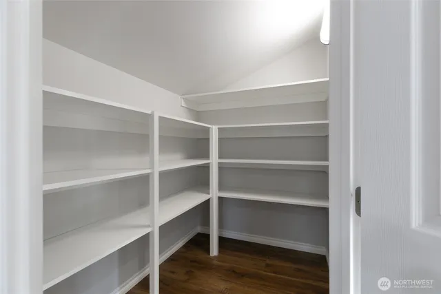 a view of walk in closet with empty racks