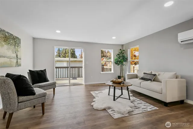 a living room with furniture and wooden floor