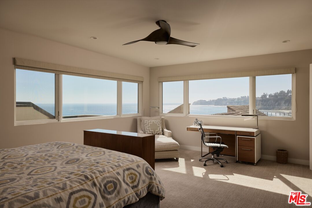 28026 Sea Ln Drive Malibu, CA 90265 - Photo 21 of 37 a bedroom with a bed and a large window