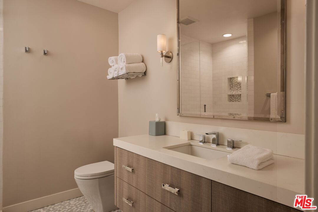 28026 Sea Ln Drive Malibu, CA 90265 - Photo 24 of 37 a bathroom with a sink a toilet and a mirror
