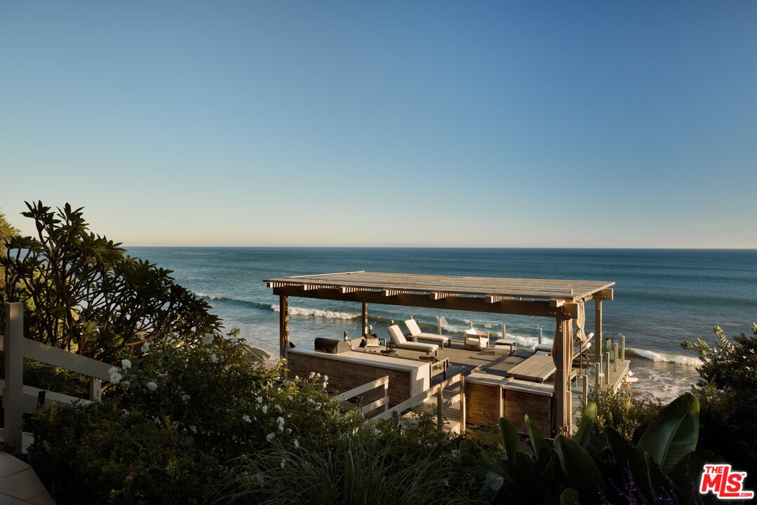 28026 Sea Ln Drive Malibu, CA 90265 - Photo 6 of 37 a view of a balcony with chairs and a potted plant