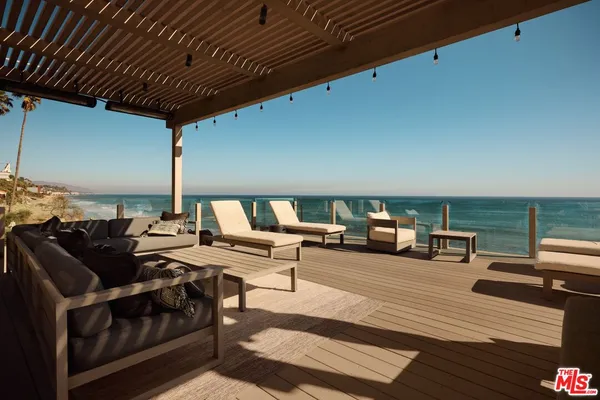 a terrace of a house with outdoor seating