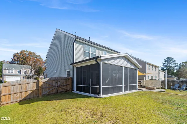 a view of a house with a backyard and porch