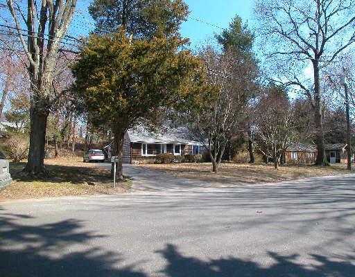 306 Adley Road Fairfield, CT 06825 - Photo 1 of 1 a front view of a house with a yard covered with snow