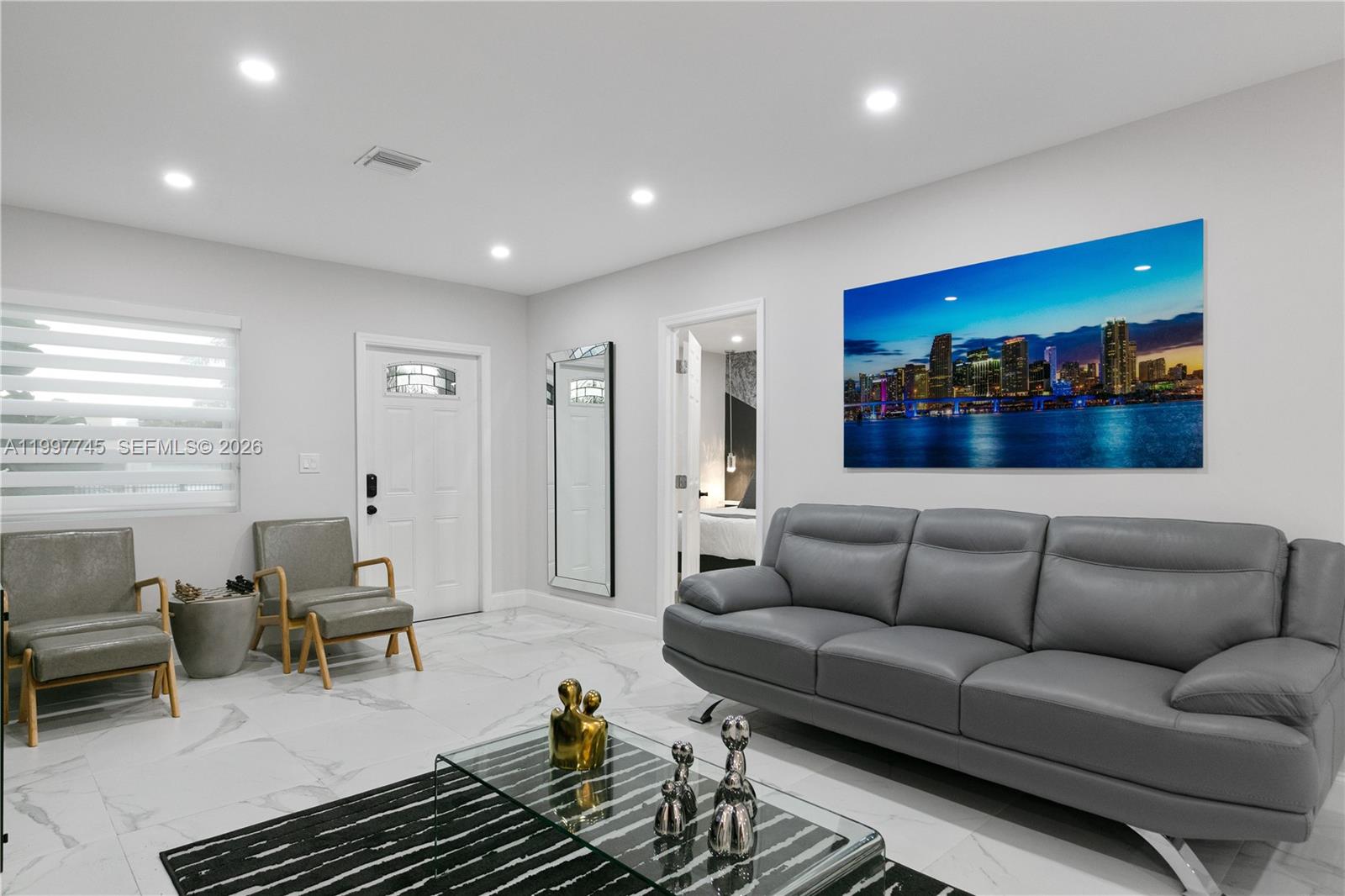 2376 Northwest 2nd Street Miami, FL 33125 - Photo 11 of 77 a living room with furniture and a glass door