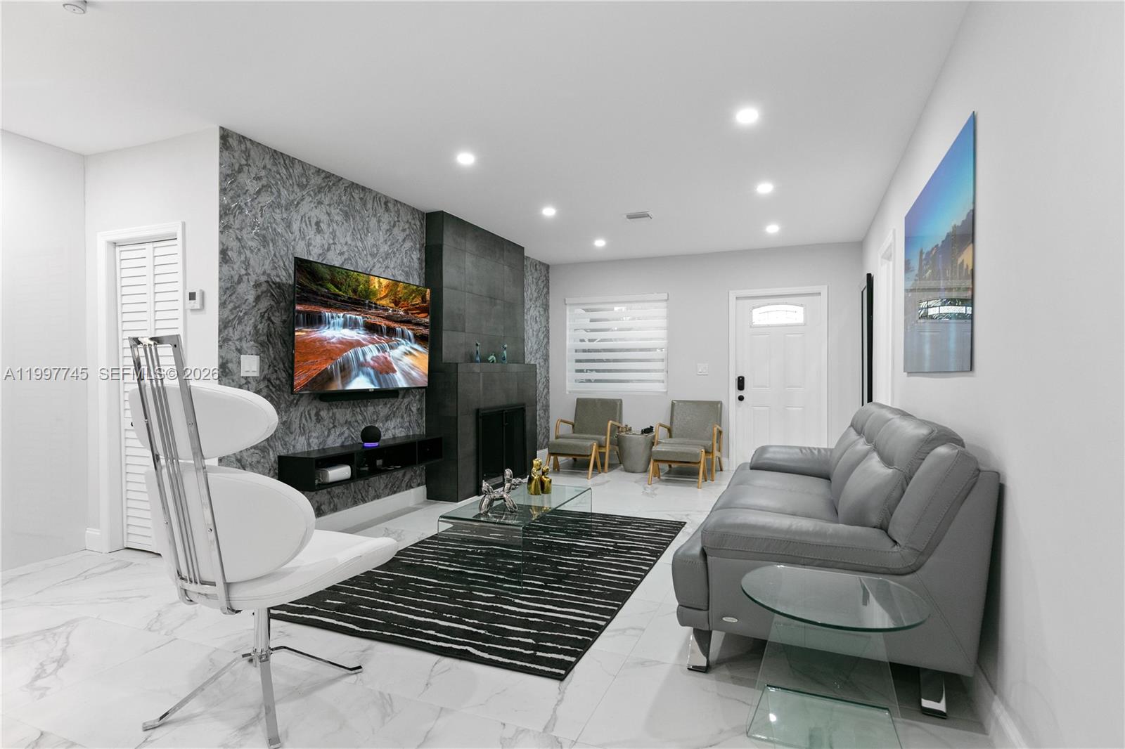 2376 Northwest 2nd Street Miami, FL 33125 - Photo 12 of 77 a living room with furniture and a flat screen tv