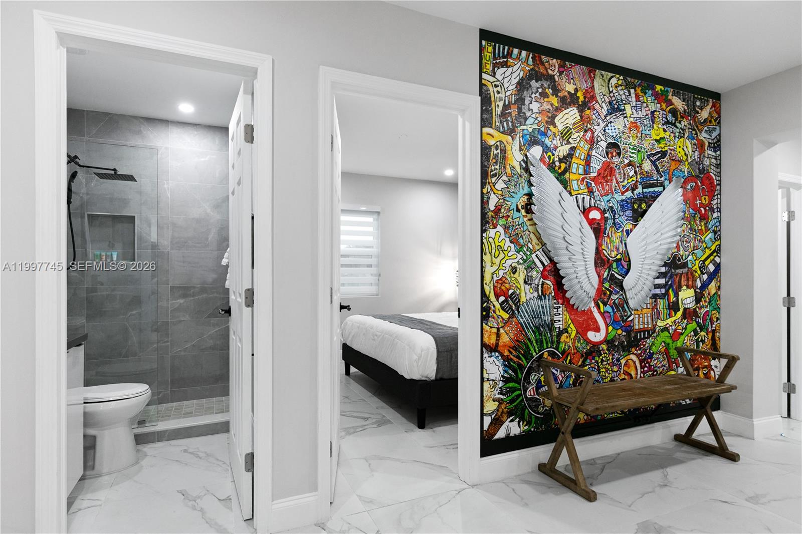 2376 Northwest 2nd Street Miami, FL 33125 - Photo 15 of 77 a view of a bedroom with paintings on the wall and a shower curtain