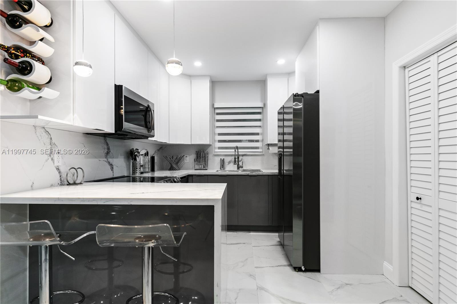 2376 Northwest 2nd Street Miami, FL 33125 - Photo 22 of 77 a kitchen with a sink cabinets and stainless steel appliances