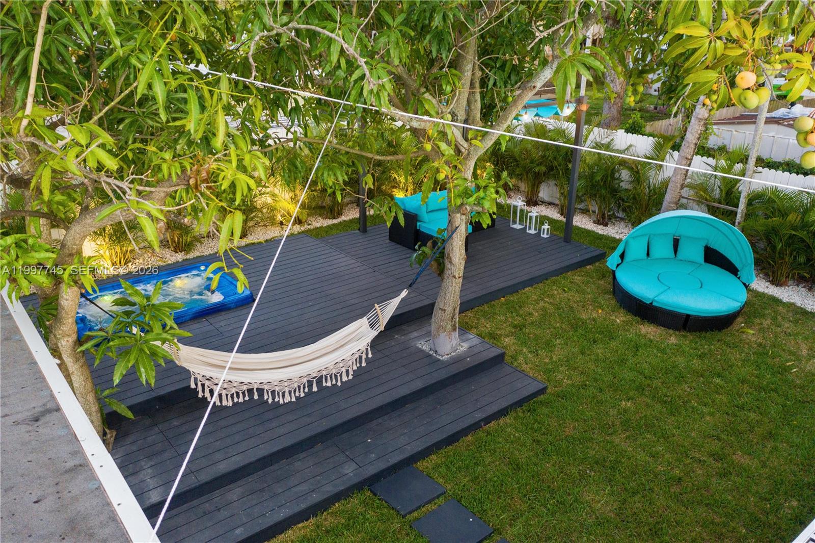 2376 Northwest 2nd Street Miami, FL 33125 - Photo 32 of 77 a backyard of a house with table and chairs