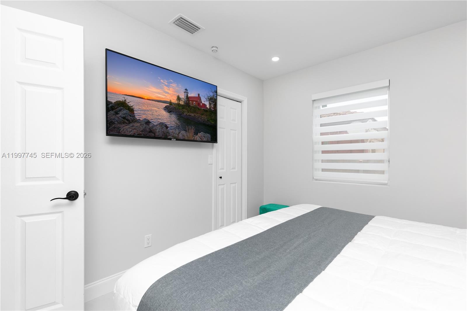 2376 Northwest 2nd Street Miami, FL 33125 - Photo 48 of 77 a bedroom with a bed and a flat screen tv