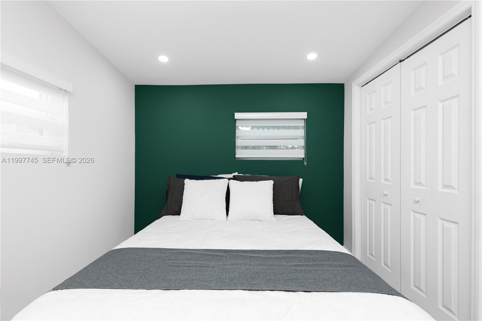 2376 Northwest 2nd Street Miami, FL 33125 - Photo 49 of 77 a bedroom with a bed and a window