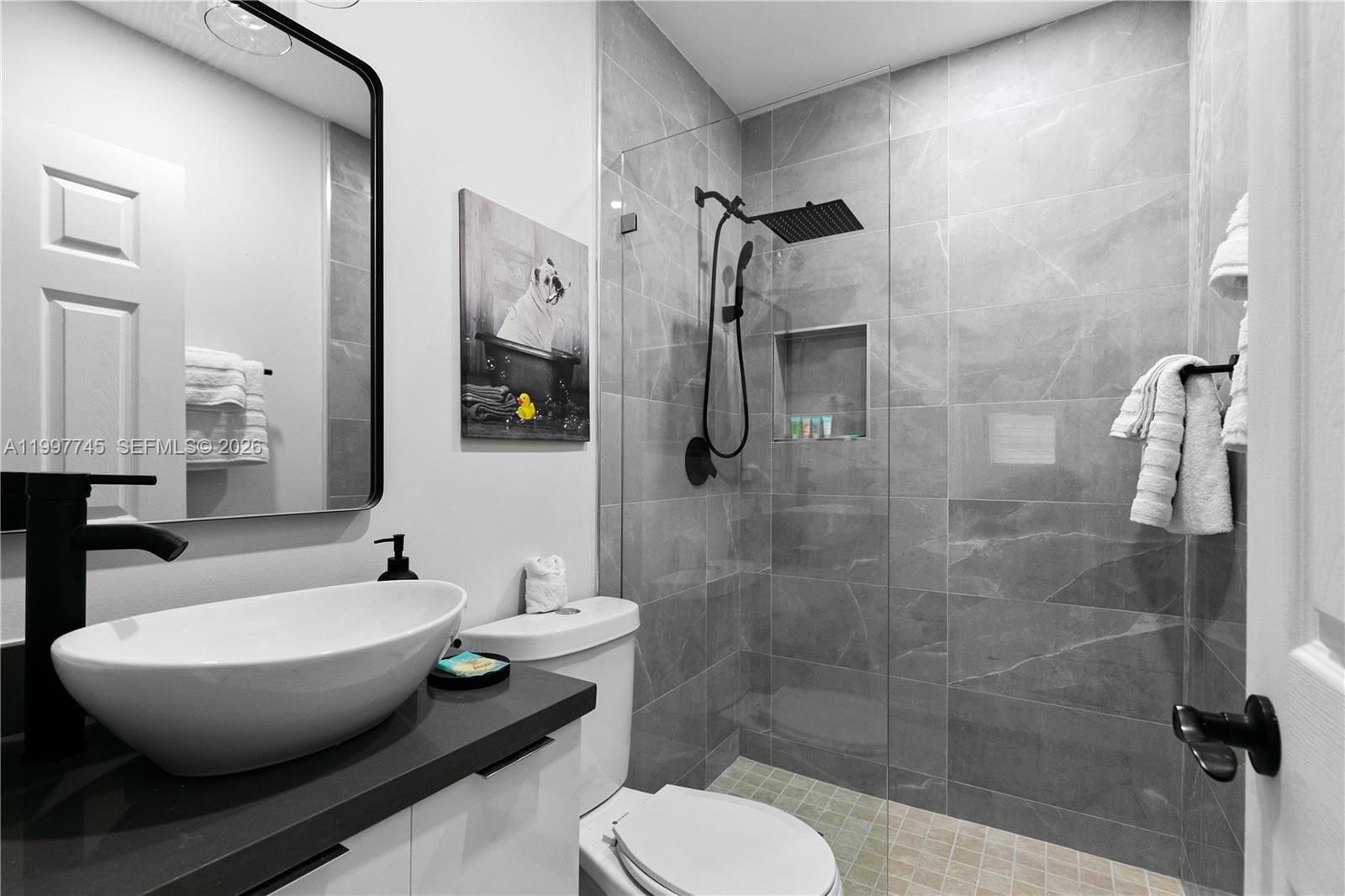 2376 Northwest 2nd Street Miami, FL 33125 - Photo 50 of 77 a bathroom with a toilet and a shower