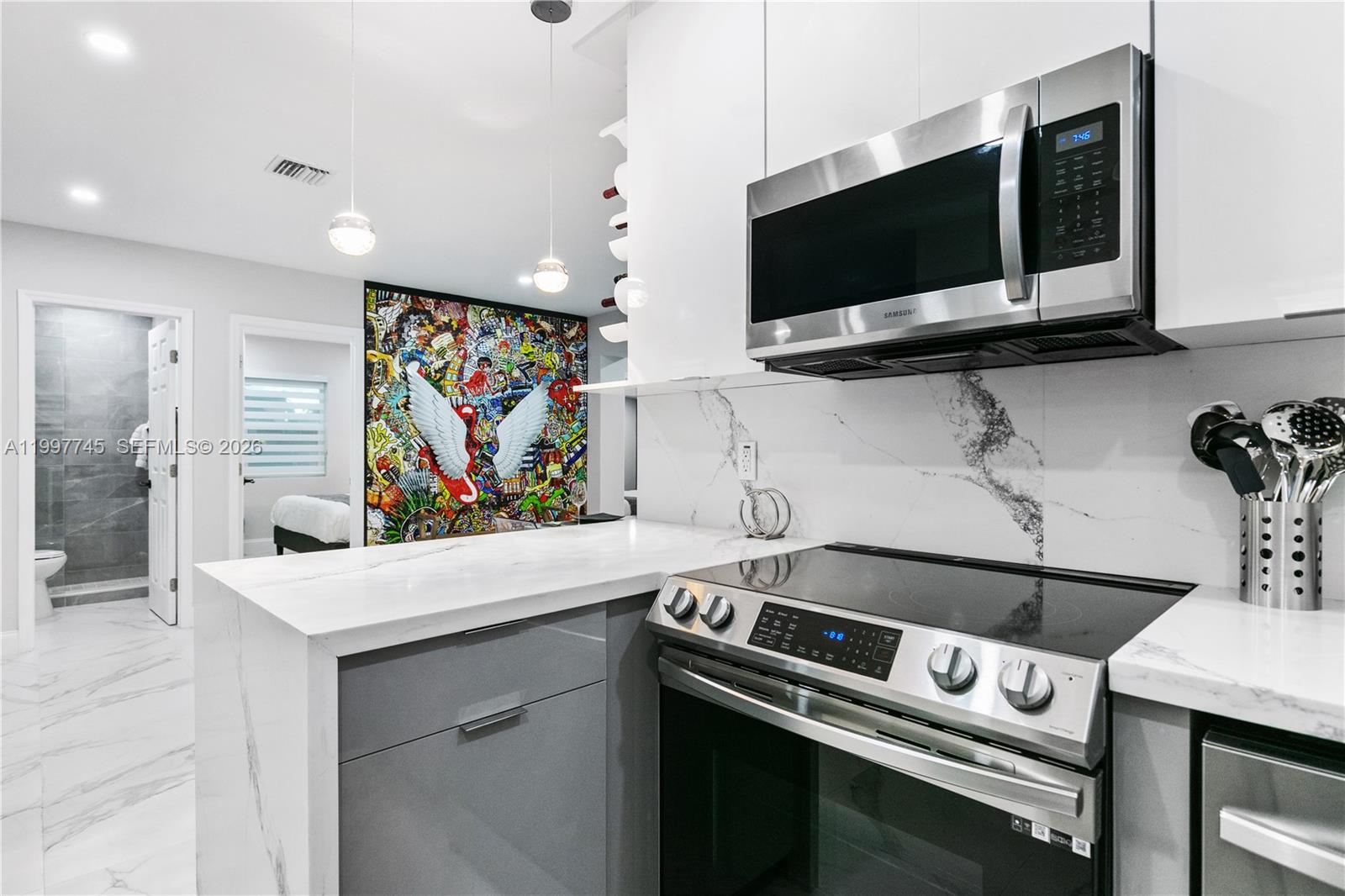 2376 Northwest 2nd Street Miami, FL 33125 - Photo 52 of 77 a view of kitchen with stainless steel appliances white cabinets and stove