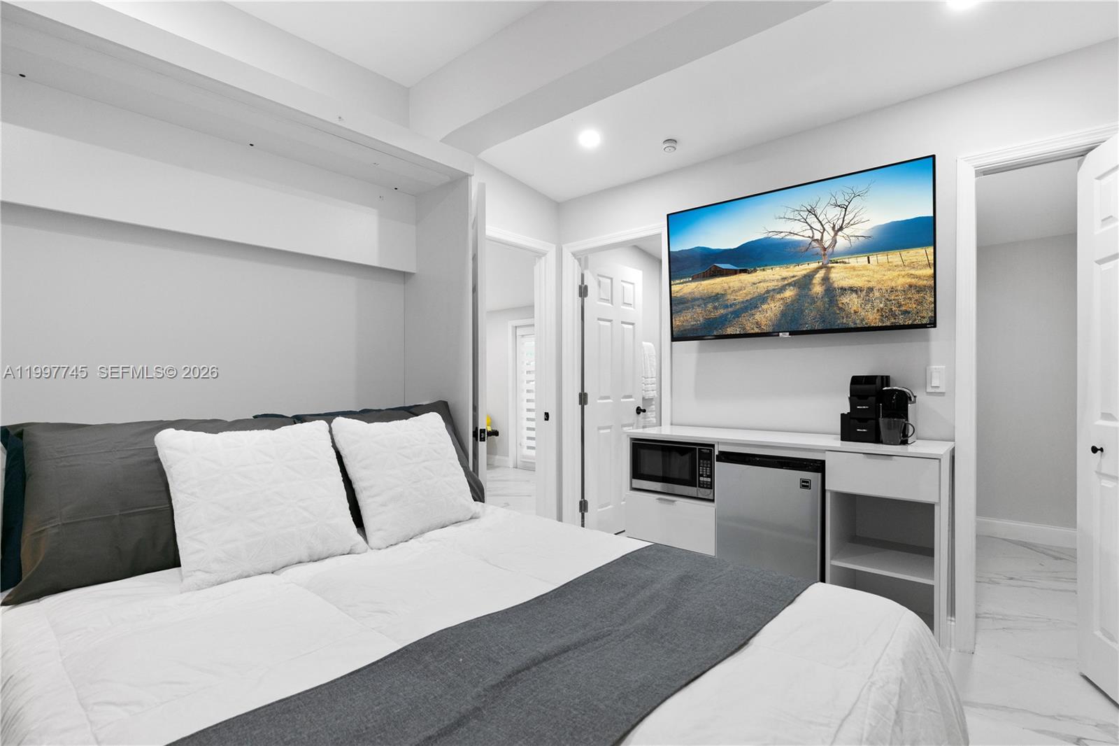 2376 Northwest 2nd Street Miami, FL 33125 - Photo 54 of 77 a bedroom with a bed and a flat screen tv