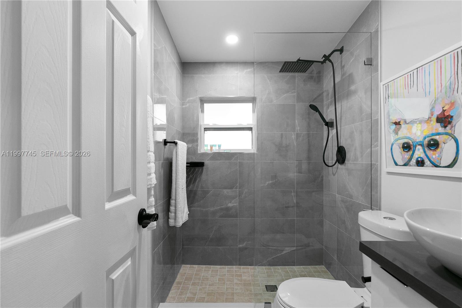 2376 Northwest 2nd Street Miami, FL 33125 - Photo 57 of 77 a bathroom with a shower a toilet and sink
