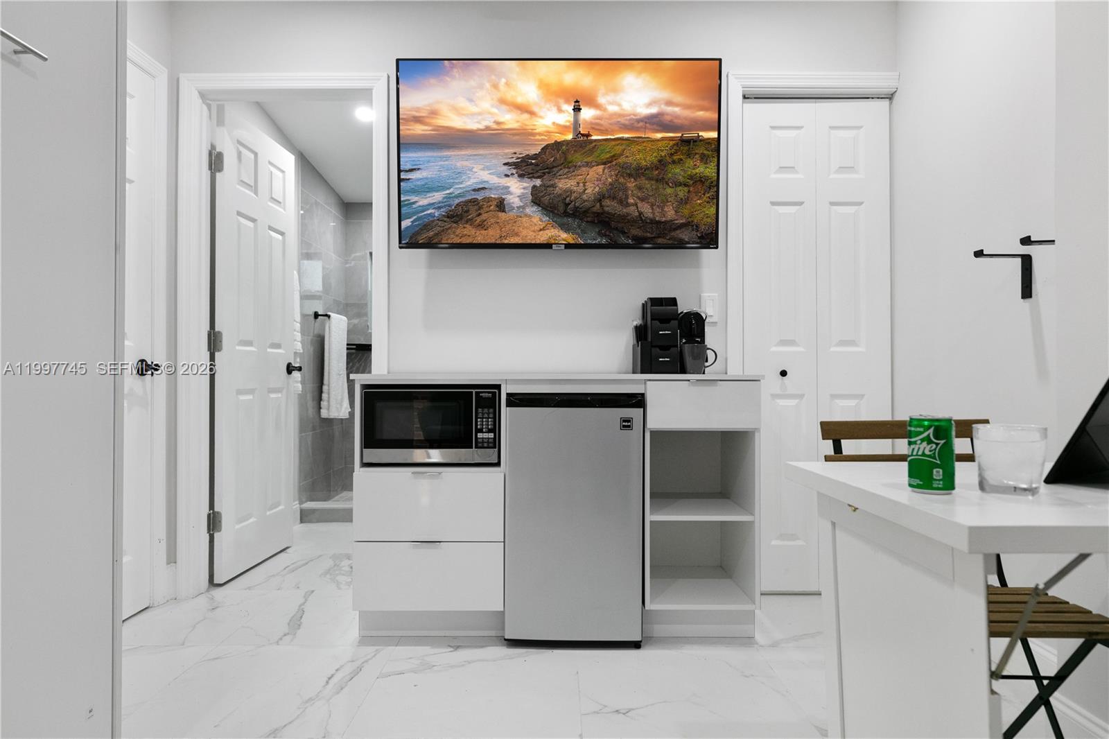 2376 Northwest 2nd Street Miami, FL 33125 - Photo 62 of 77 a kitchen with stainless steel appliances kitchen island granite countertop a refrigerator and a stove top oven