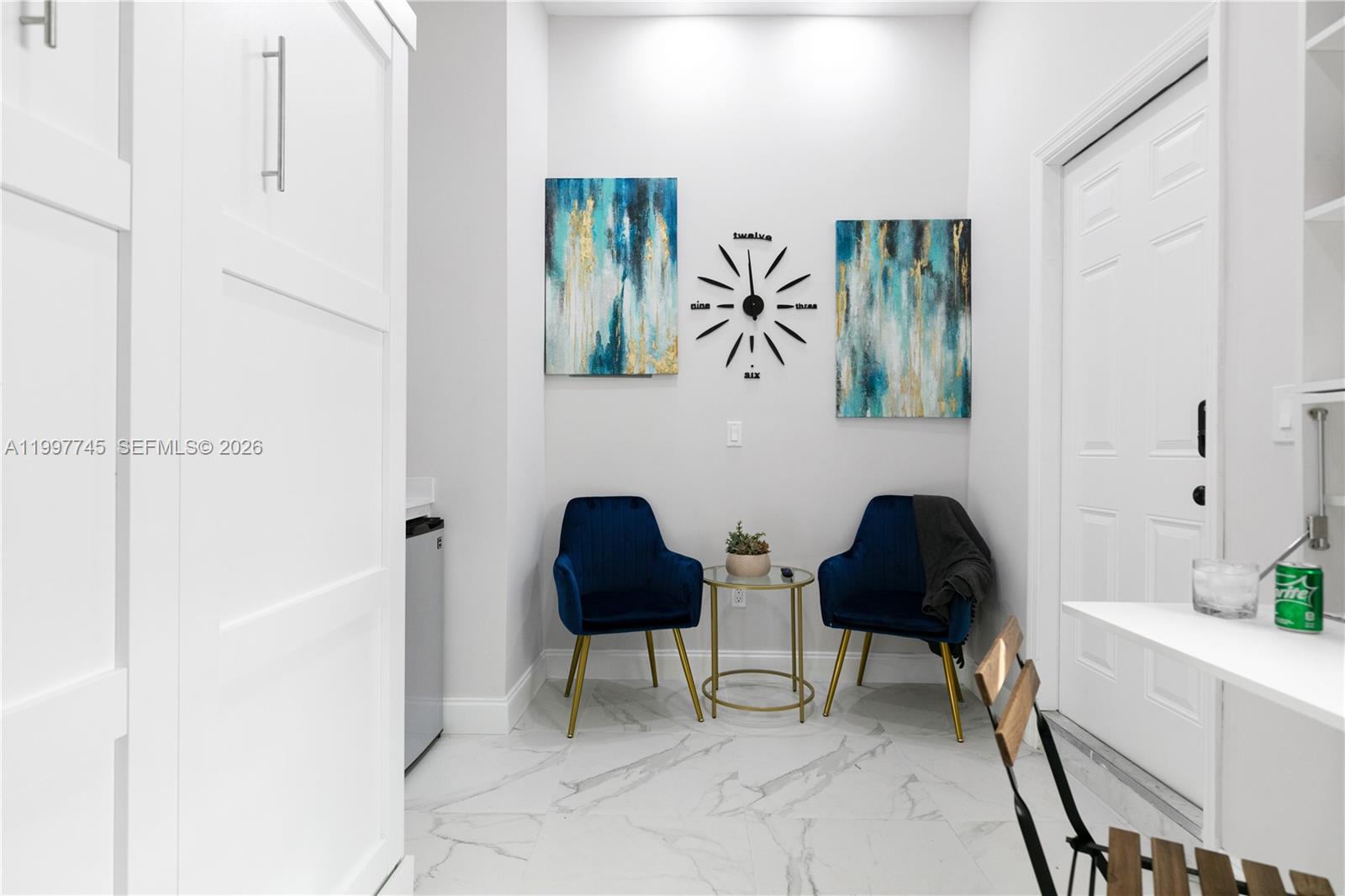 2376 Northwest 2nd Street Miami, FL 33125 - Photo 68 of 77 a living room with furniture and a painting on the wall