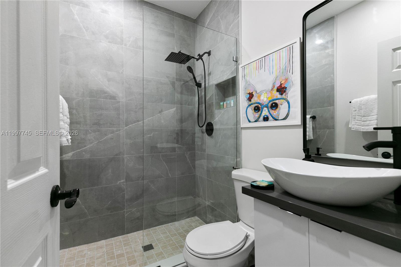 2376 Northwest 2nd Street Miami, FL 33125 - Photo 70 of 77 a bathroom with a toilet a sink and shower