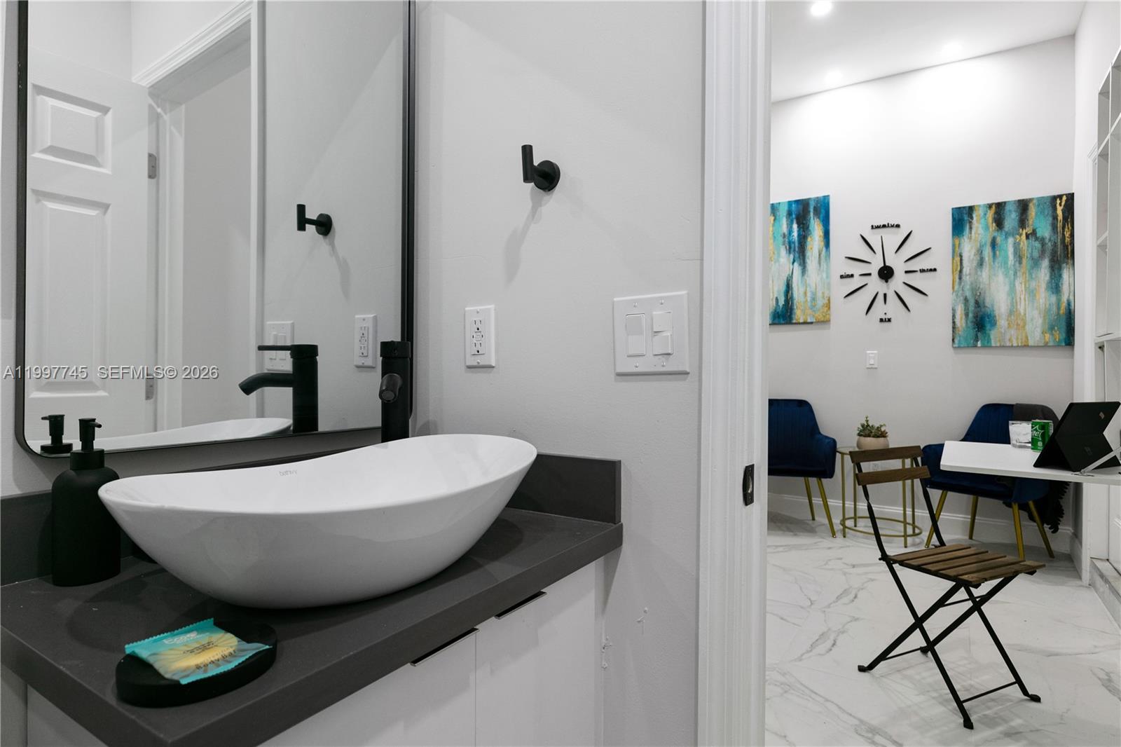 2376 Northwest 2nd Street Miami, FL 33125 - Photo 72 of 77 a room with table chairs and mirrors
