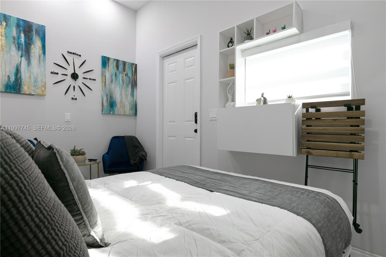 2376 Northwest 2nd Street Miami, FL 33125 - Photo 73 of 77 a bedroom with a bed and a window