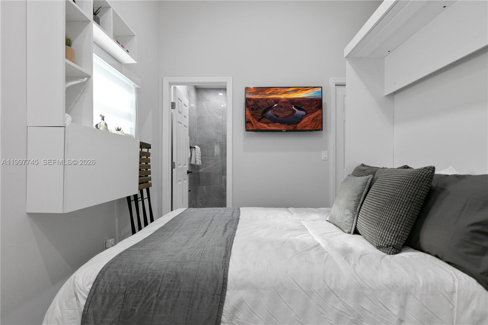 2376 Northwest 2nd Street Miami, FL 33125 - Photo 74 of 77 a bedroom with a bed and a painting on the wall