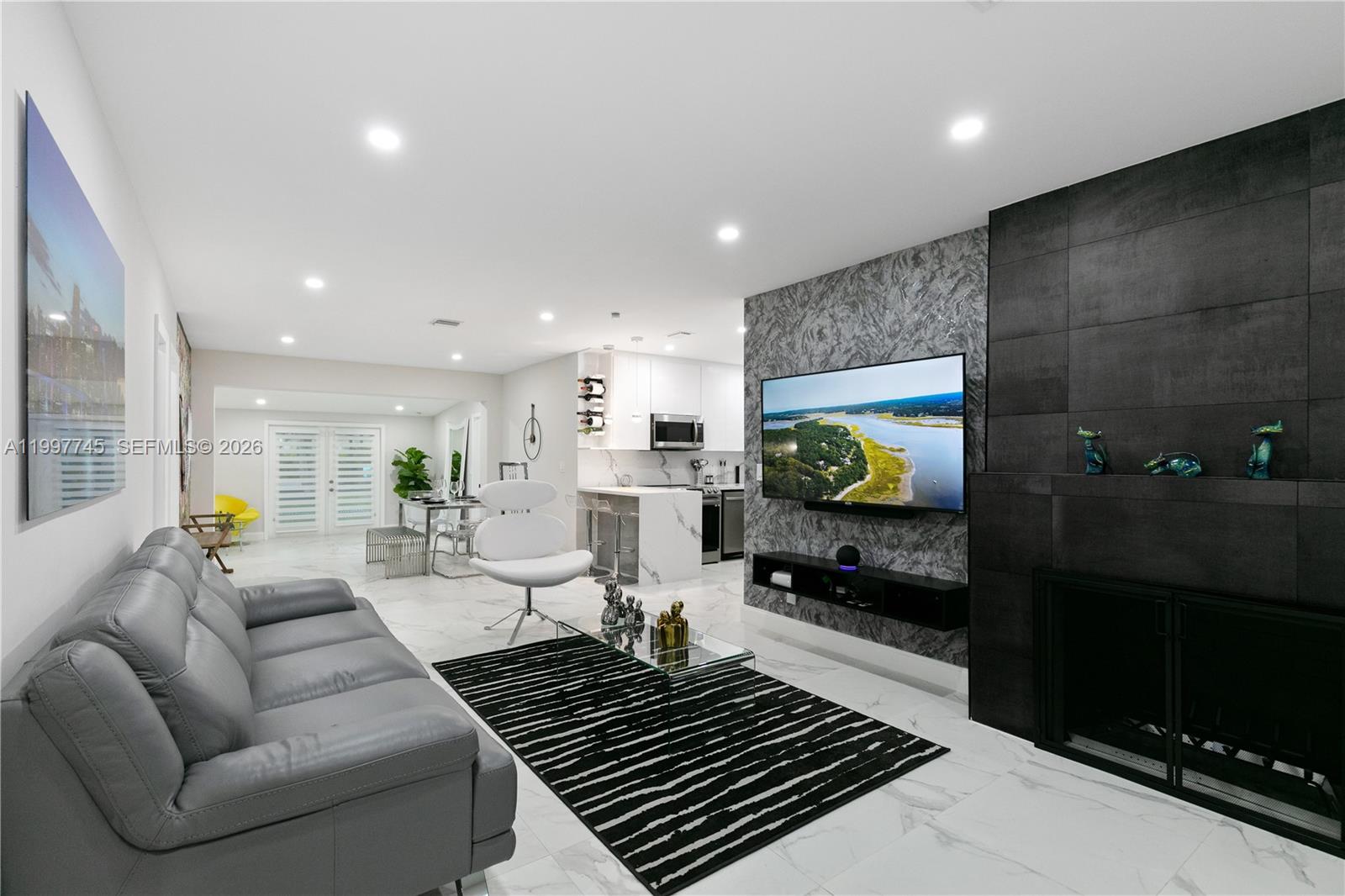 2376 Northwest 2nd Street Miami, FL 33125 - Photo 8 of 77 a living room with furniture and a flat screen tv
