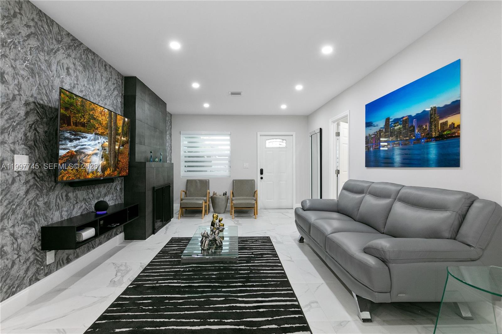 2376 Northwest 2nd Street Miami, FL 33125 - Photo 10 of 77 a living room with furniture and a flat screen tv