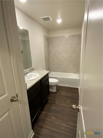 a bathroom with a sink a toilet a shower and a mirror