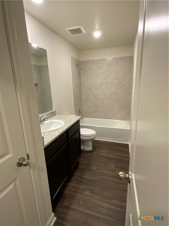 208 Allington Circle Jarrell, TX 76537 - Photo 14 of 16 a bathroom with a sink a toilet a shower and a mirror