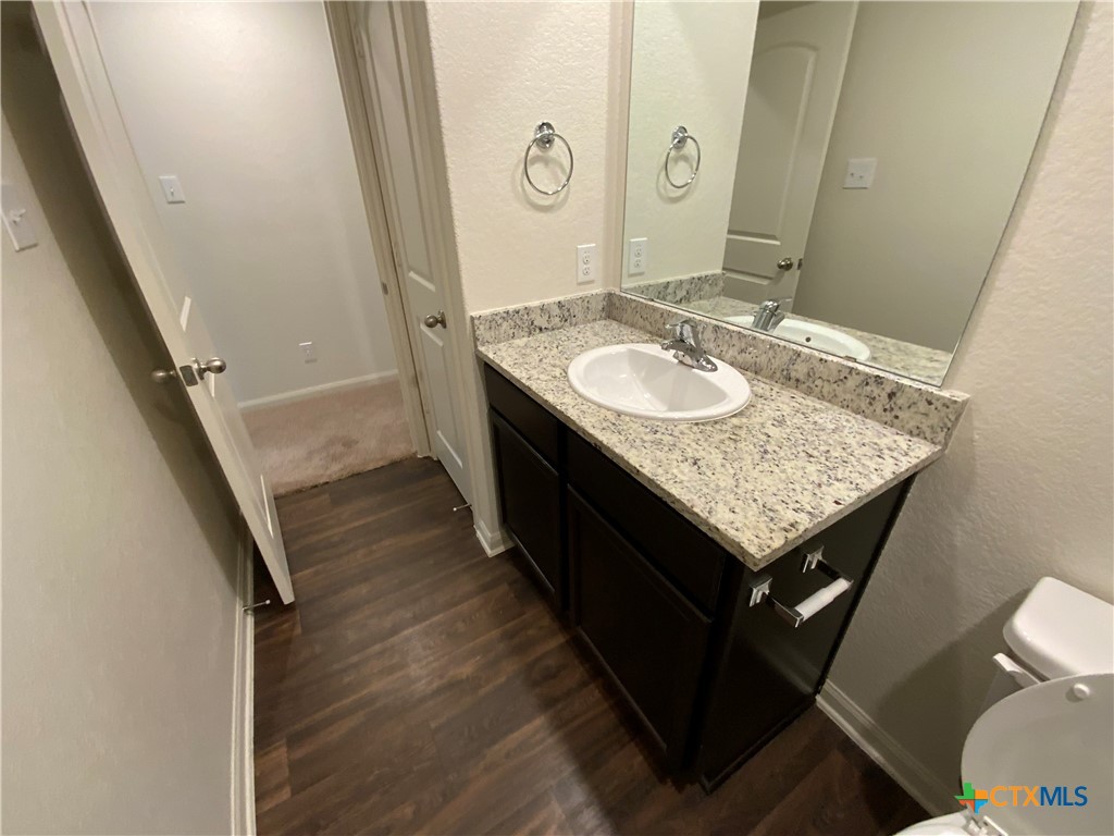 208 Allington Circle Jarrell, TX 76537 - Photo 6 of 16 a bathroom with a granite countertop sink and a mirror